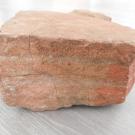 Фрагмент доменной печи Повенецкого чугунолитейного завода.<br />1-я треть ХVIII в.<br />Камень.<br />Размеры: 19,5 х 19 х 9,5 см.